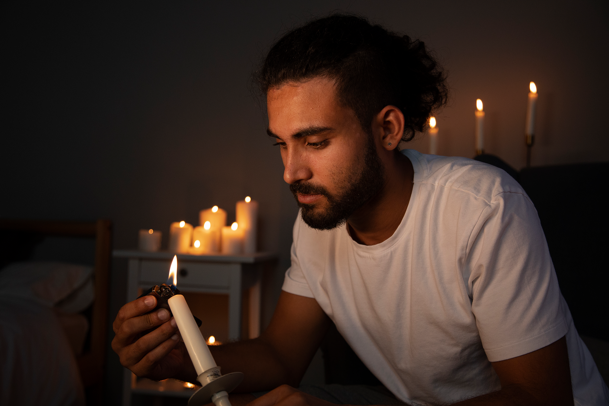 Image by <a href="https://www.freepik.com/free-photo/side-view-man-lighting-candle_28476142.htm#page=2&query=blackout&position=4&from_view=search&track=sph">Freepik</a>